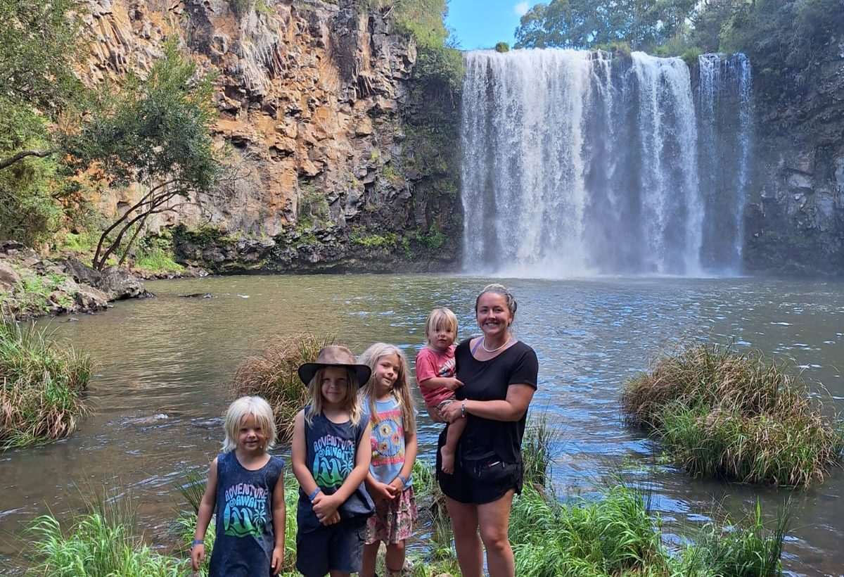 Homeschool family exploring near a waterfall
